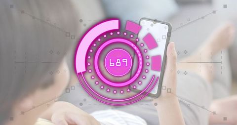 Reclining asian man holding smartphone with magenta hud interface on living room sofa