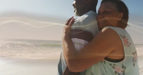 Romantic Mature Couple Embracing by Ocean Shoreline