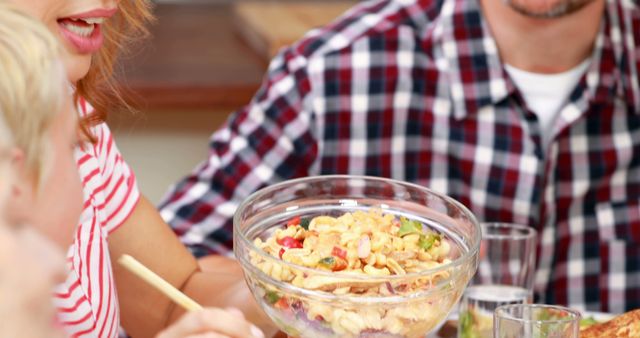 Family Enjoying Meal with Homemade Pasta Salad at Table - Download Free Stock Images Pikwizard.com