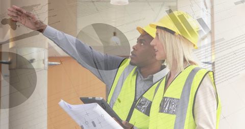 Architects Wearing Safety Gear Analyzing Building Plans - Download Free Stock Images Pikwizard.com