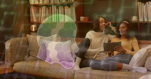 Two friends relaxing on couch using tablet with digital skull ai overlay concept