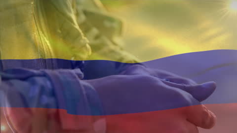 Colombian Flag Waving Over Soldier Reloading Magazine