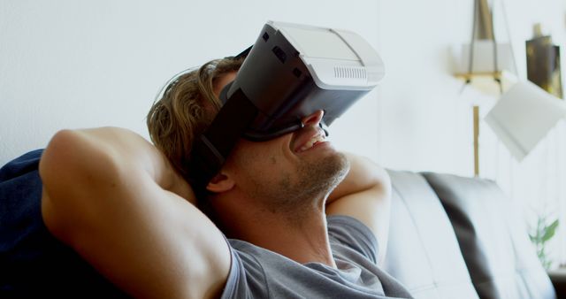 Relaxed Young Man Enjoying VR Experience on Couch - Download Free Stock Images Pikwizard.com