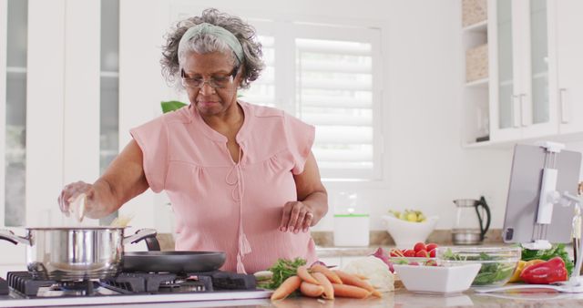 Senior African American Woman Cooking Healthy Meal in Kitchen - Download Free Stock Images Pikwizard.com