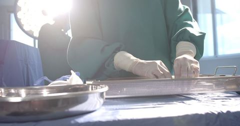 Surgeon arranging tools under sterile conditions in operating room