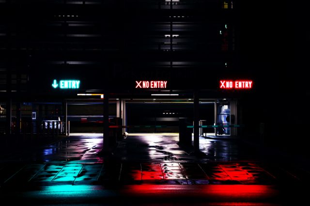 Empty Urban Parking Garage at Night with Neon Entry Signs - Download Free Stock Photos Pikwizard.com
