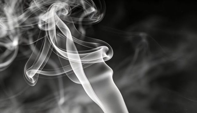 Curling Smoke Ribbons Over Black Backdrop, High-Contrast Monochrome Abstract