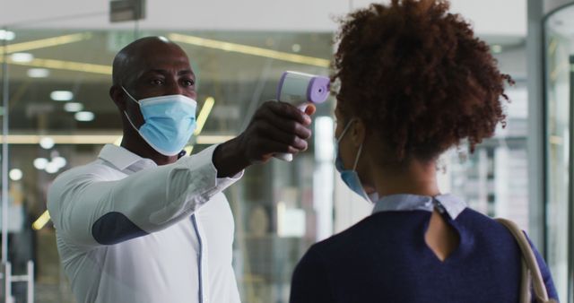 Healthcare worker checking body temperature of woman - Download Free Stock Images Pikwizard.com