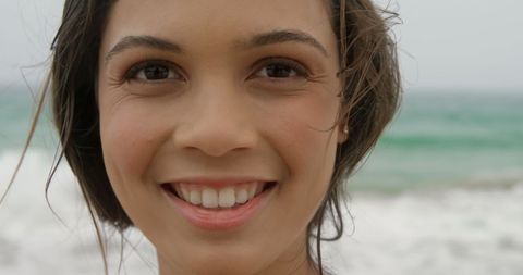 Smiling Woman by Ocean Offering Bright Expression - Download Free Stock Images Pikwizard.com