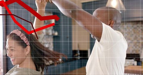 Couple dancing in modern kitchen with red declining graph overlay and white grid