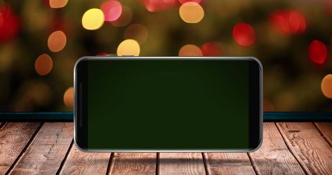 Christmas Smartphone Display with Festive Blurred Lights - Download Free Stock Images Pikwizard.com