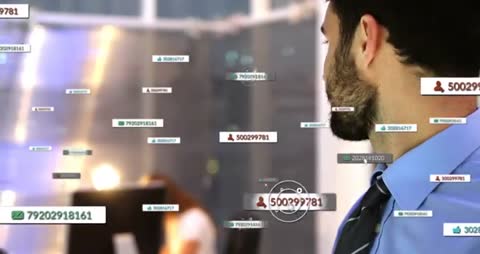 Businessman monitoring floating digital alerts and HUD overlays while tapping tablet in office