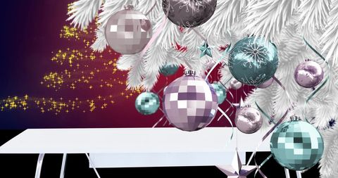 Festive white christmas tree with ornaments and glowing background