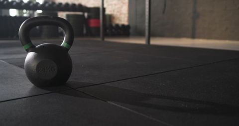 Kettlebell on Gym Floor with Shadow in Modern Fitness Space