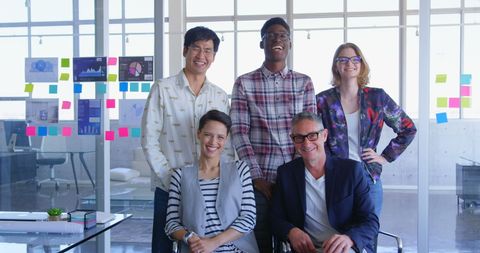 Diverse Business Team Smiling and Posing in Modern Office