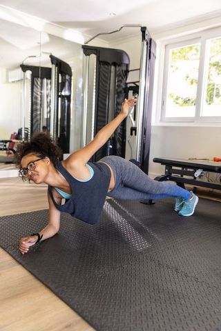 African American Woman Doing Side Plank Home Gym Workout