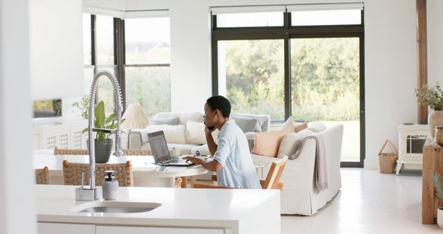 Young Man Working from Home in Bright Modern Living Room - Download Free Stock Images Pikwizard.com