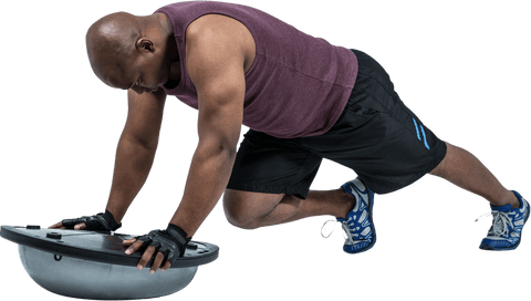 Fit man performing push-up with transparent bosu ball