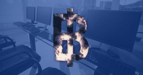 Cryptocurrency concept with bitcoin symbol over office computers