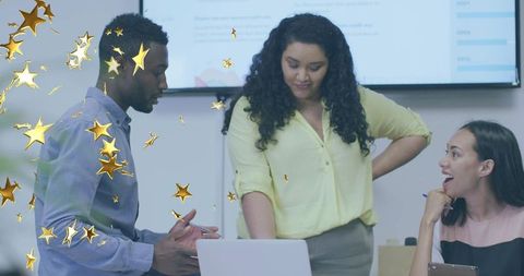 Business team reviewing laptop presentation celebrating success with gold star overlay