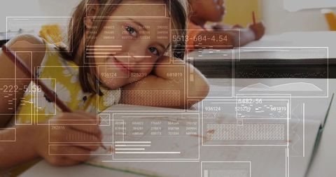 Student focusing on writing project at desks in classroom
