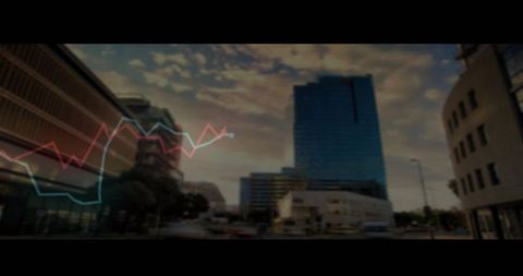 Cityscape with Line Graph Chart Overlay Reflecting Sunset on Skyscraper