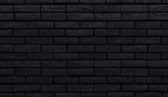 Close up of black brick walls created using generative ai technology. Texture, colour and pattern concept, digitally generated image.