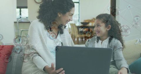 Mother and Daughter Using Laptop with Digital Network Overlay for Remote Learning and Bonding
