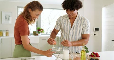 Diverse Couple Preparing Meal in Modern Kitchen Together