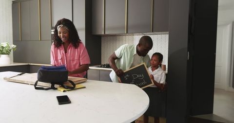 African american family preparing for first day of school in modern minimalist kitchen