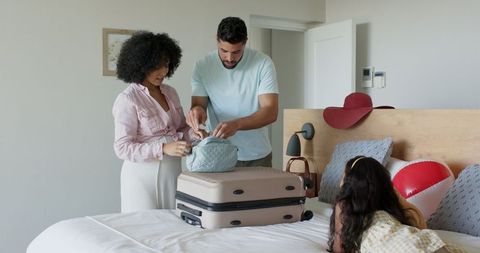 Diverse Family Packing Suitcase for Exciting Vacation