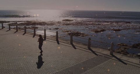 Woman enjoying solitary stroll along scenic oceanfront path