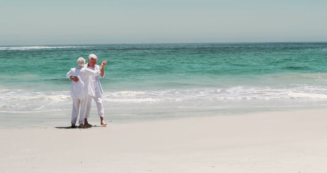 Senior Couple Enjoying a Romantic Walk on Beach - Download Free Stock Images Pikwizard.com