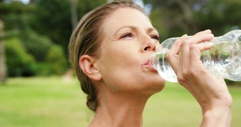 Mature woman enjoying refreshing water outdoors