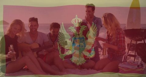 Young Friends Relaxing on Beach with Guitar at Sunset