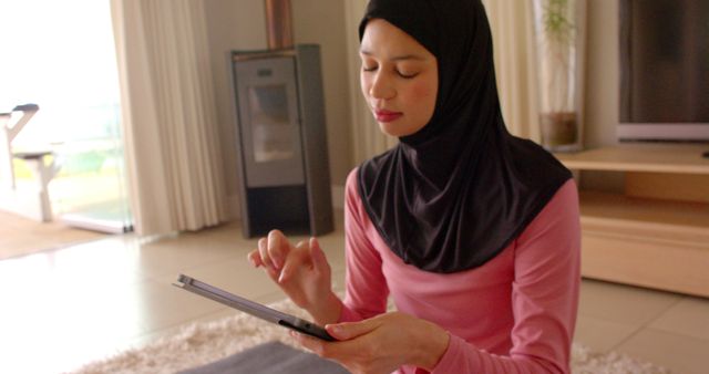 Muslim woman in hijab using tablet indoors - Download Free Stock Images Pikwizard.com