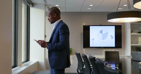 Businessman Strategizing with Tablet in Modern Office