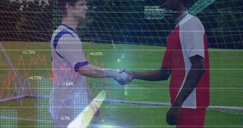 Male soccer players shaking hands with data graphics overlay