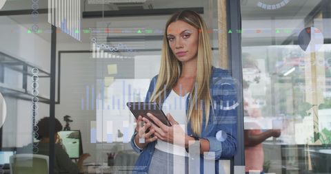 Businesswoman Analyzing Digital Financial Charts in Modern Office