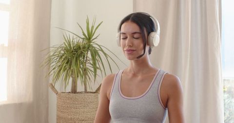Woman Meditating with Headphones in Calm Living Room