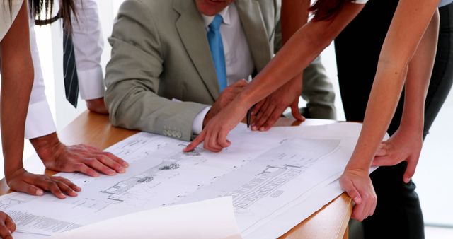 Business Team Discussing Architectural Blueprint at Meeting - Download Free Stock Images Pikwizard.com