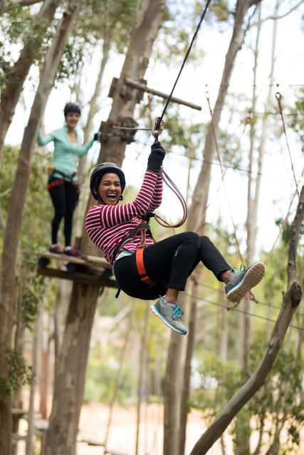 Smiling woman on zipline in adventure park
