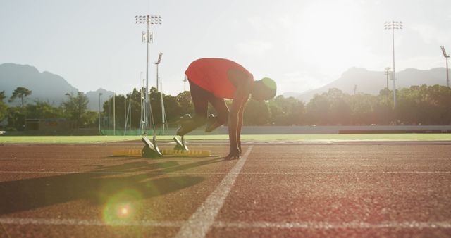 Athlete Preparing for Sprint on Track at Sunset - Download Free Stock Images Pikwizard.com