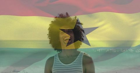 Laughing young man celebrating on beach with ghana flag overlay and black star emblem