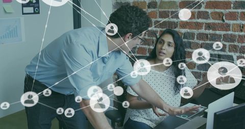 Diverse Colleagues Collaborating on Networking Project in Modern Office