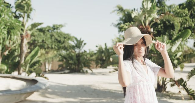 Woman in white summer dress enjoying sunny day in tropical garden - Download Free Stock Images Pikwizard.com