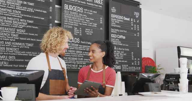 Friendly Cafe Staff in Front of Menu Board Interacting - Download Free Stock Images Pikwizard.com