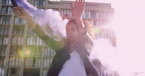 Woman Joyfully Holding Smoke Flare Outdoors in Sunlight - Download Free Stock Images Pikwizard.com