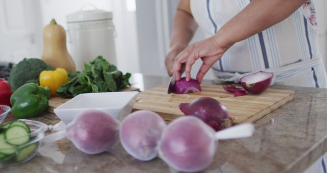 Hands Chopping Red Onion with Variety of Fresh Vegetables on Kitchen Counter - Download Free Stock Images Pikwizard.com