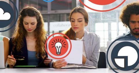 Multiracial Business Team Analyzing Reports in Modern Office